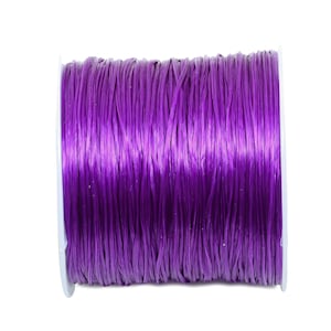 May include: A spool of purple elastic cord.