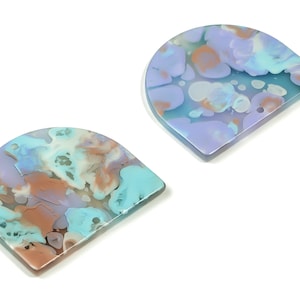 May include: Two half-circle shaped resin pieces with a marbled pattern in shades of blue, purple, and brown.