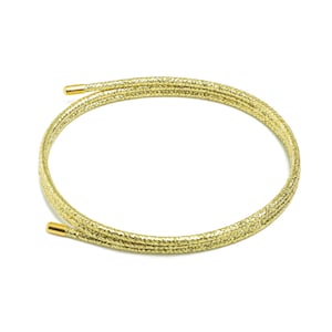 May include: A gold glitter cord with gold-toned metal ends. The cord is coiled into a circle.