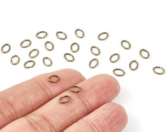 Anneaux ouverts en laiton - 6 x 5 x 0,8 mm - Plaqué bronze antique - Anneaux ouverts en laiton - Non soudés - Accessoires bijoux - PP1645AB