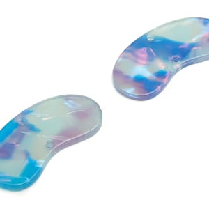 May include: Two iridescent blue, white, and pink plastic kidney-shaped buttons with holes.