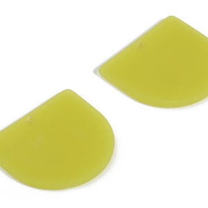 May include: Two yellow, semi-circular, plastic shapes with a hole in the top. The shapes are flat and smooth.