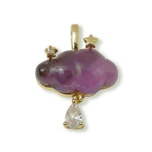 May include: A gold-coloured pendant shaped like a cloud, with a purple centre and a clear teardrop-shaped gem hanging below. The cloud has a small star and a crown on top.