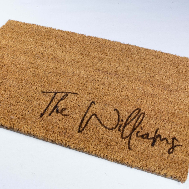 May include: A brown coir doormat with the text "The Williams" written in cursive.