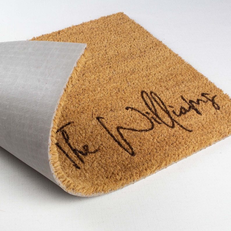 May include: A brown coir doormat with the text "The Williams" in black cursive lettering.