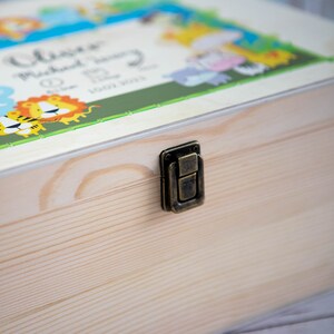 May include: A wooden keepsake box with a brass latch. The lid features a colorful illustration of jungle animals and the text "Olivia Michael Henry 10.11.2021".