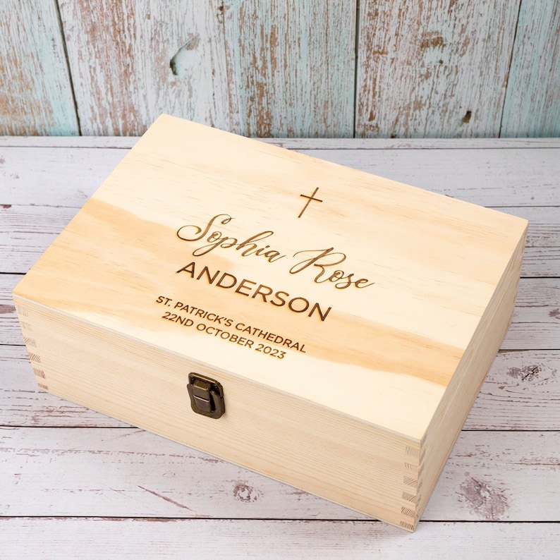 May include: A light wood keepsake box with a cross and the inscription "Sophia Rose Anderson, St. Patrick's Cathedral, 22nd October 2023".