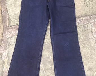 May include: Dark blue denim jeans with a straight leg fit. The jeans have a classic five-pocket style and a zip fly.