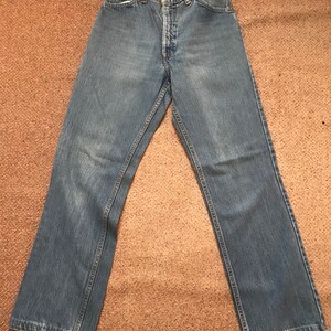 May include: A pair of light blue denim jeans with a high waist and a straight leg.