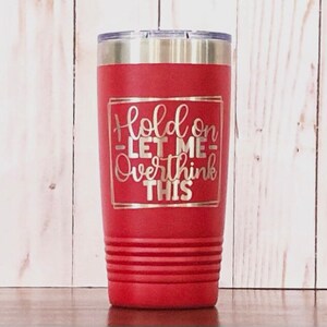May include: Red stainless steel tumbler with a white inscription that reads "Hold on let me overthink this".