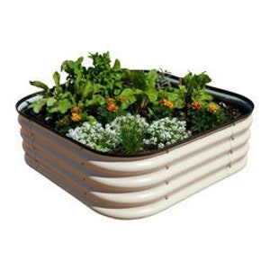 May include: A raised garden bed made of corrugated metal with a cream-colored finish. The bed is filled with soil and various plants, including leafy greens, flowers, and herbs.