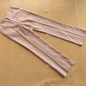May include: A pair of light brown checkered pants with a straight leg.