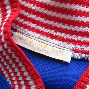 May include: A white tag with gold lettering that reads "Fun Fads of Palm Springs, California". The tag is attached to a blue and white striped knit collar.