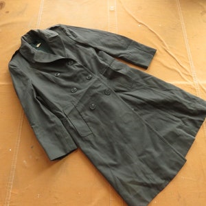 May include: A dark green double-breasted coat with a long length and a collar.