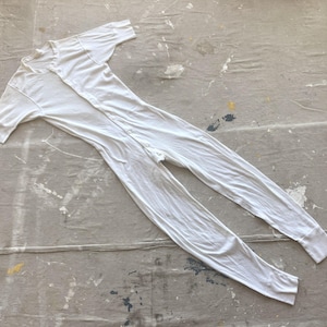 May include: White long-sleeved thermal underwear with a snap closure down the front.