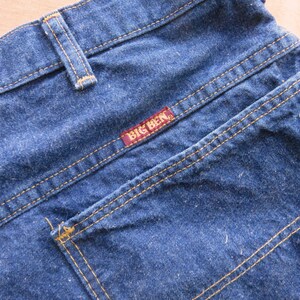 May include: Blue denim jeans with a back pocket and a red label that says "BIG BEN".