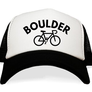 May include: A white and black trucker hat with a black bicycle graphic and the word "BOULDER" in black text.