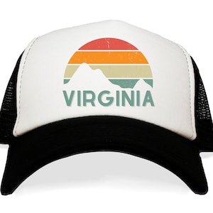 May include: A white trucker hat with a black mesh back. The front panel features a retro design of a sunset over mountains, with the word "VIRGINIA" in a teal font.