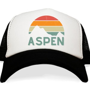 May include: A white and black trucker hat with a retro sunset graphic and the word "ASPEN" in green text.