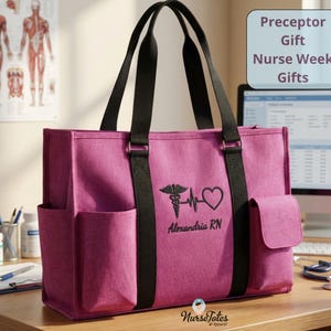 May include: A magenta tote bag with black handles and accents. The bag features a medical symbol and a heart with the text "Alexandria RN". The bag has multiple pockets and the text "Preceptor Gift Nurse Week Gifts".