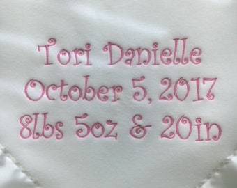 May include: White baby blanket with pink embroidered lettering that reads "Tori Danielle October 5, 2017 8lbs 5oz & 20in"