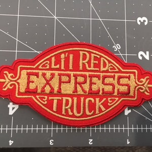 May include: Red embroidered patch with gold lettering that reads "Lil' Red Express Truck".