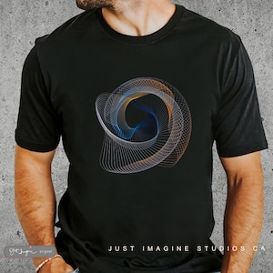 May include: A black t-shirt featuring a graphic design of a swirling, multi-coloured abstract pattern. The text "JUST IMAGINE STUDIOS CA" is printed on the bottom of the shirt.