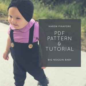 Puede incluir: Un bebé con un atuendo negro y morado con un turbante negro. El texto de la imagen dice "HAREM PINAFORE PDF PATTERN & TUTORIAL BIG NOGGIN BABY".