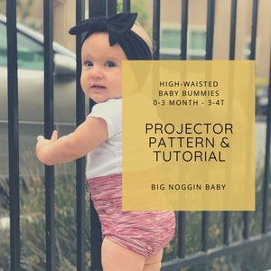 May include: A baby wearing a white shirt and pink and white striped high-waisted shorts. The baby is standing next to a black metal fence. The image has text that reads "HIGH-WAISTED BABY BUMMIES 0-3 MONTH - 3-4T PROJECTOR PATTERN & TUTORIAL BIG NOGGIN BABY".