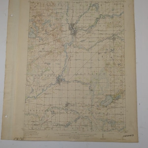 May include: A vintage topographical map with the title "TOPOGRAPHY" at the top. The map features detailed lines, grids, and place names, with a focus on a river and surrounding areas. The map is printed on aged paper with visible wear and tear.