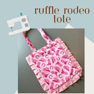 May include: Pink tote bag with a ruffle trim and a pattern of cowboy boots, hats, and horseshoes. The bag has handles and the text "ruffle rodeo tote". The image also includes text about easy instructions and a video tutorial.