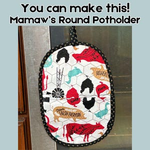 May include: A round potholder with a farm theme. The white fabric features red, black, and teal farm animal illustrations and the text "Farm Fresh Everyday" and "Home". The potholder is trimmed with black and gold fabric and has a black loop.