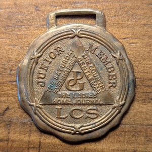 Philadelphia, Pennsylvania Curtis Publishing Co. Ladies Home Journal The Saturday Evening Post Brass Advertising Watch Fob
