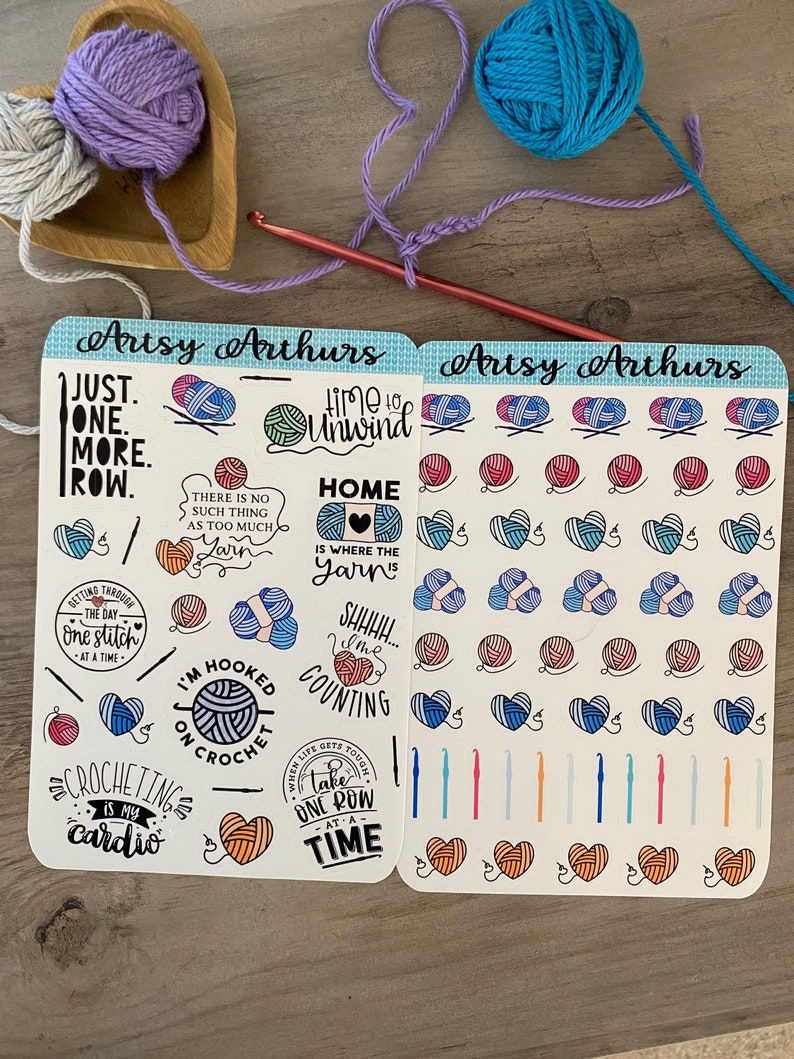Peut inclure: Deux feuilles d'autocollants sur le th&egrave;me du crochet. Les autocollants pr&eacute;sentent des pelotes de laine color&eacute;es, des crochets &agrave; crochet et des citations inspirantes sur le crochet. Le texte sur les autocollants comprend "Just one more row", "Time to unwind", "Home is where the yarn is", "I'm hooked on crochet", "Crocheting is my cardio", et "When life gets tough take one row at a time".