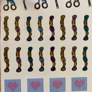 May include: A sheet of stickers featuring a variety of embroidery-themed designs. The stickers include blue birds holding scissors, spools of thread in various colors, and cross-stitch hearts.