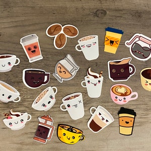 May include: A collection of 16 colorful stickers featuring various coffee and tea cups with cute cartoon faces. The stickers are on a woodgrain background.