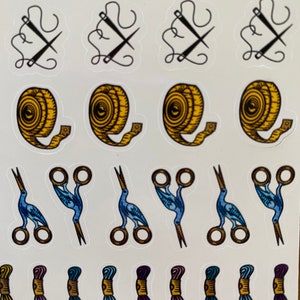 May include: A sheet of stickers featuring various sewing and crafting supplies, including needles, thread, scissors, and measuring tape. The stickers are colorful and feature a variety of designs.
