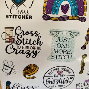 May include: A set of colorful cross stitch themed stickers with various designs and sayings, including "Cross Stitch to Burn Off the Crazy", "Just One More Stitch", "Getting Through the Day One Stitch at a Time", and "Floss Every Day".