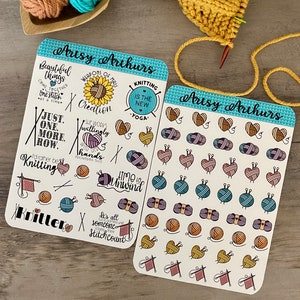 May include: Two sheets of stickers with a blue and white border. The stickers feature various knitting-themed illustrations, including yarn balls, needles, and hearts. The text on the stickers includes phrases like "Just one more row", "Knitting is the new yoga", and "Time to unwind".