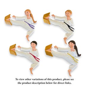 May include: Four ceramic figurines of people in karate poses, each breaking a wooden board with their foot. The figurines are wearing white karate uniforms with different colored belts. The figurines are all in different poses, showing a variety of karate moves.