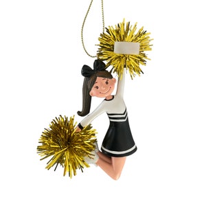 May include: A black and white cheerleader ornament with gold pom-poms. The ornament has a blank tag for personalization.