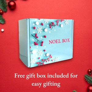 May include: A light blue gift box with a white snowflake and red berry design. The box has the text "NOEL BOX" printed on it. Free gift box included for easy gifting.