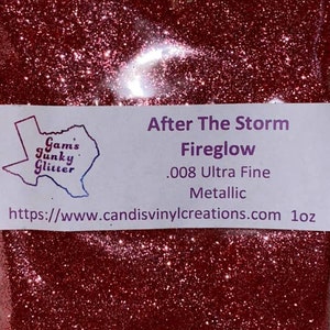 May include: A close-up of a red glitter with a label that reads "After The Storm Fireglow .008 Ultra Fine Metallic" and a website address: https://www.candisvinylcreations.com 1oz