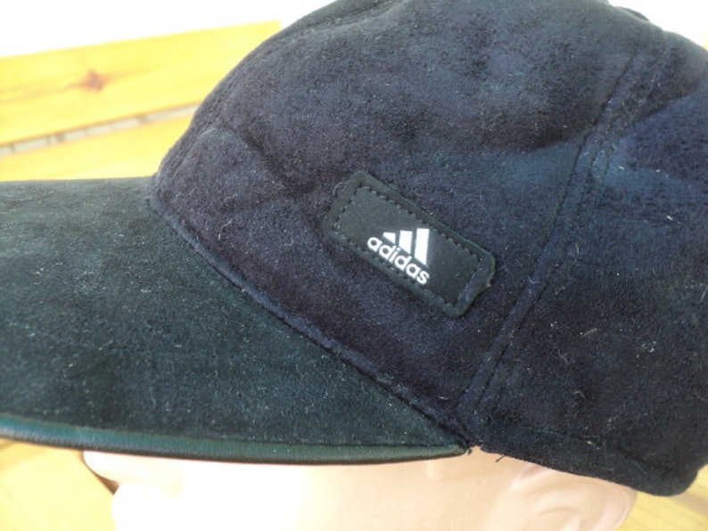 a winter cap a youth cap a men/'s baseball cap artificial leather a black cap, fur a warm hat A classic baseball cap a visor