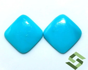 May include: Two turquoise cabochon gemstones cut in a square shape. The stones are a vibrant blue color and have a smooth, polished surface.