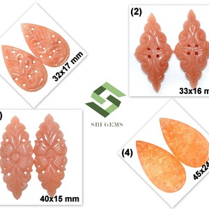 May include: Four pairs of carved peach-colored gemstone pendants. Each pair has a unique design, with sizes ranging from 32x17 mm to 45x24 mm. The pendants feature floral and ornamental patterns, suitable for jewelry making.