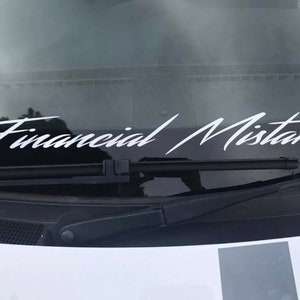 May include: A white vinyl sticker on a car windshield that reads "Financial Mistake".