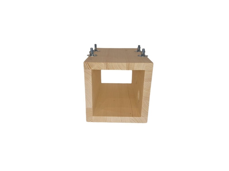 May include: A wooden box with a square opening in the front. The box is made of light wood and has four metal screws on the top.