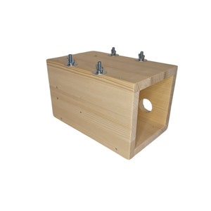 May include: A wooden box with a hole in the side, secured with metal screws. The box is made of light wood and has a natural finish.