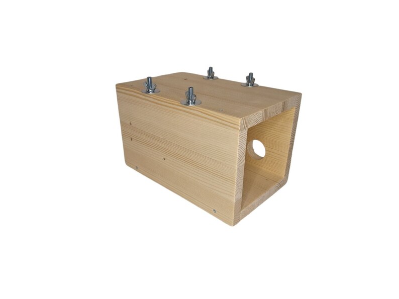 May include: A wooden box with a hole in the side, secured with metal screws. The box is made of light wood and has a natural finish.